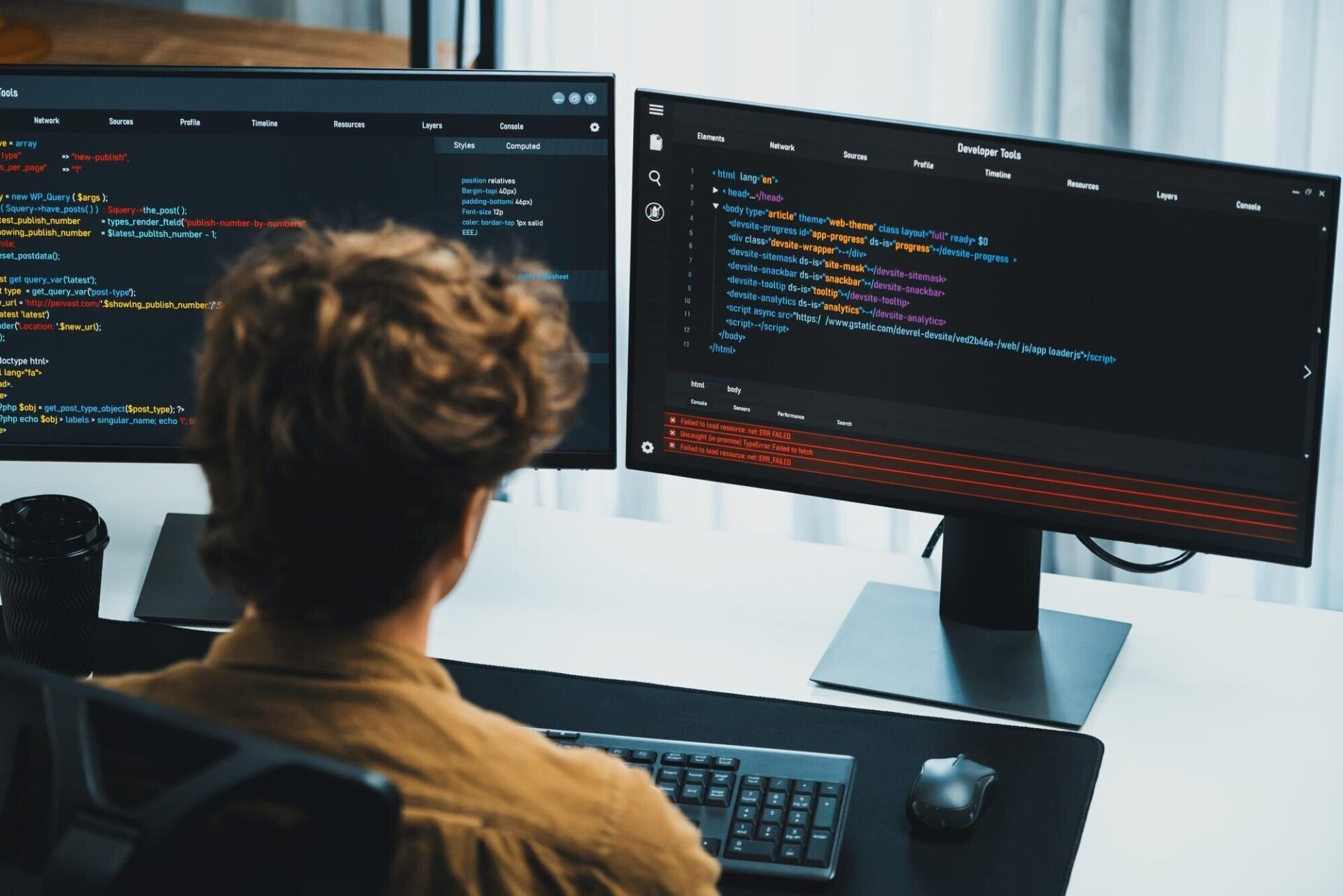 Developer coding on dual monitors in a modern workspace, representing Kautilyam’s angular web app development expertise.