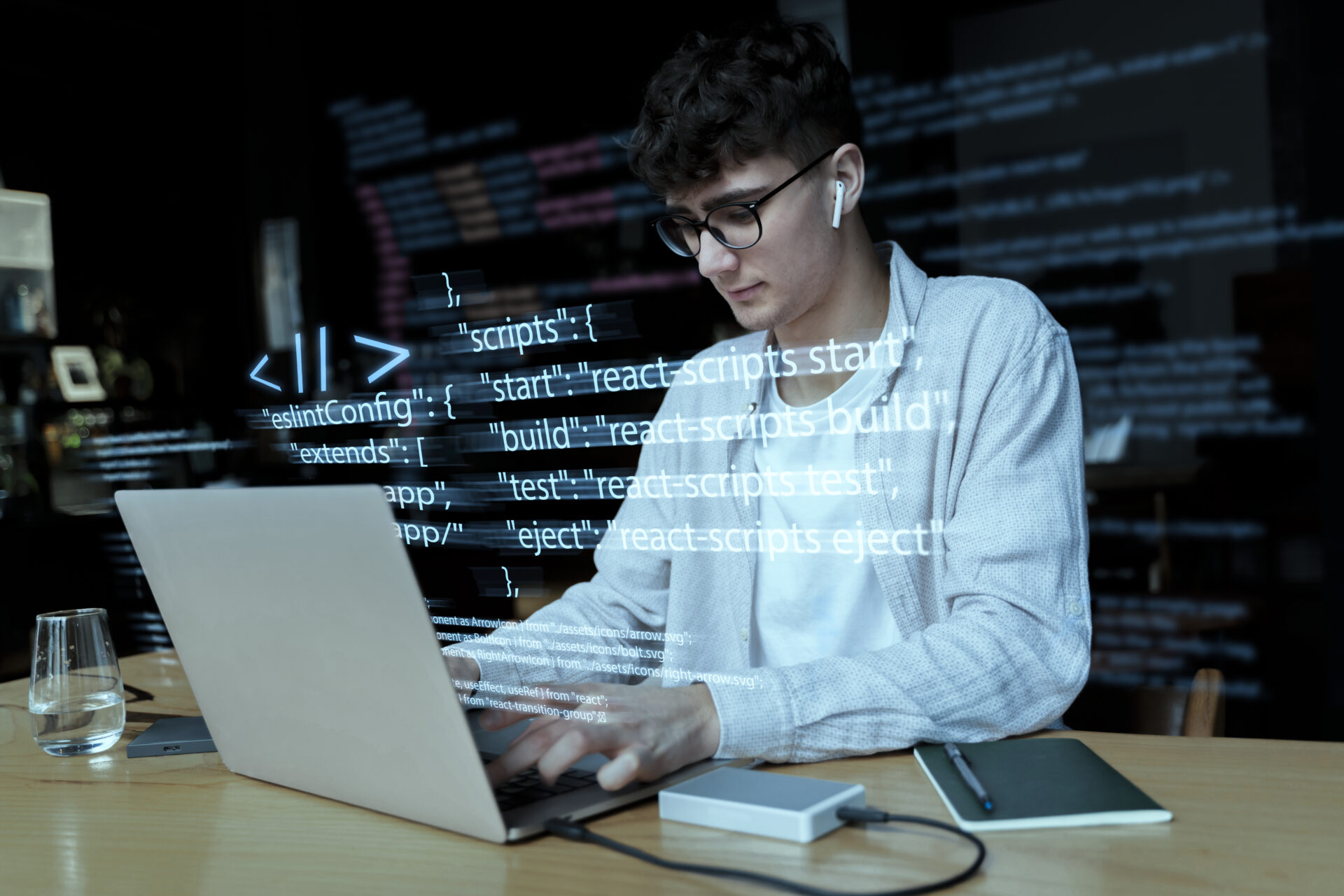 Young backend developer coding on a laptop in a modern workspace, representing Kautilyam’s expertise in backend web development solutions.