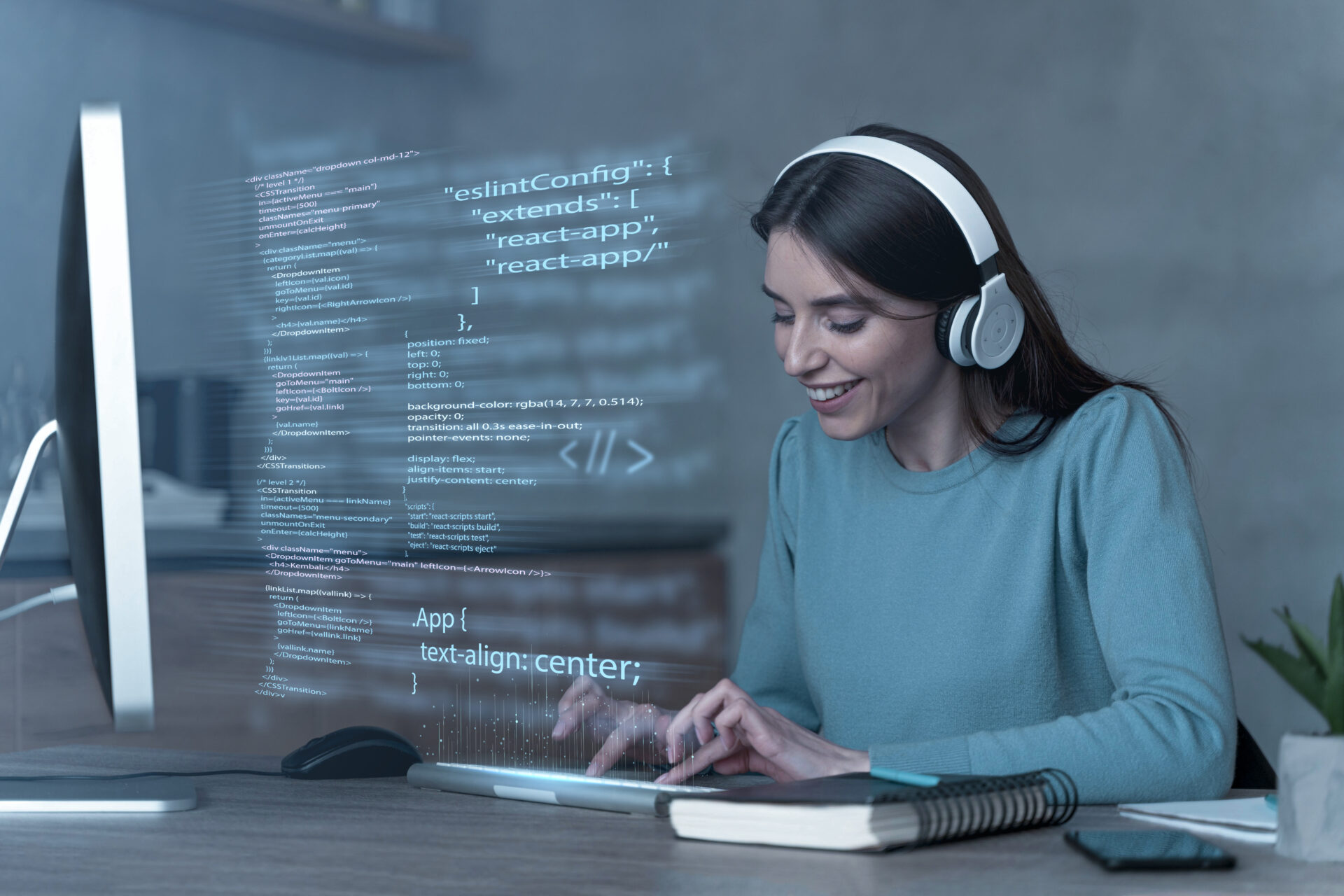 A young woman wearing headphones, smiling while typing on her laptop. Code and programming language elements float on the screen in front of her, symbolizing her work in full-stack development at Kautilyam which is best IT company in Surat.